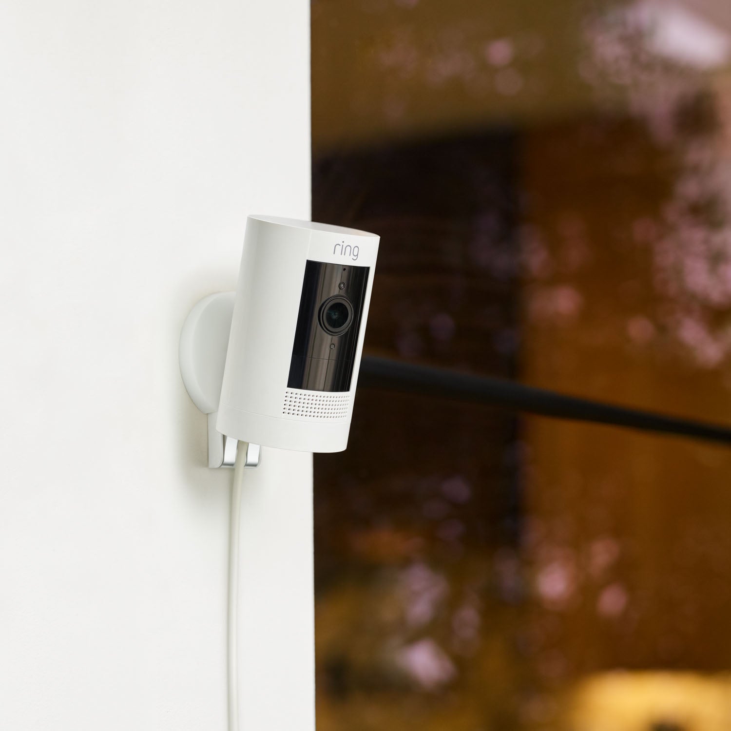 Mount for Stick Up Cam (Stick Up Cam 2nd and 3rd Generation, Stick Up Cam Elite) - Mount for Ring Stick Up Cam with plug-in camera installed on corner wall of a home.