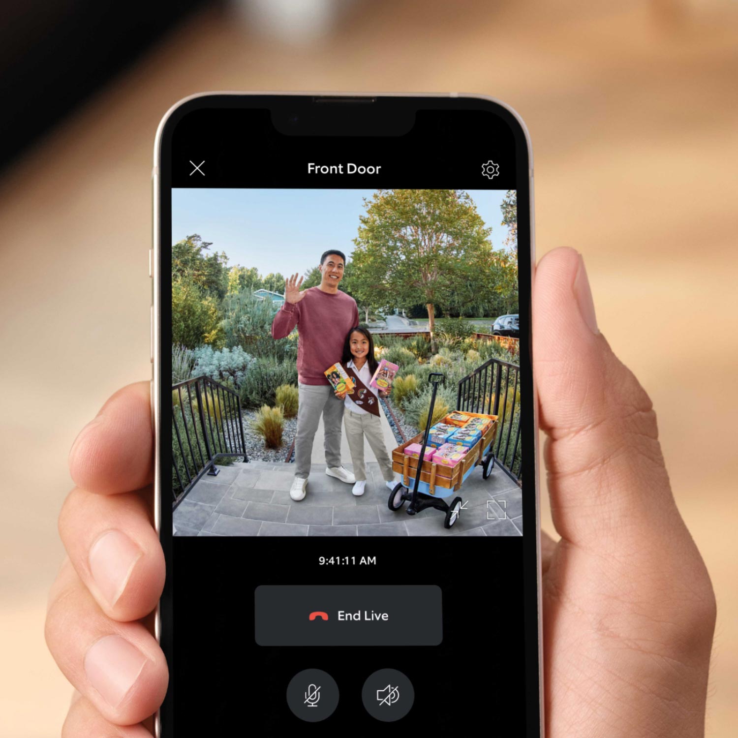 Battery Doorbell Plus with Chime Pro - Live Ring Doorbell feed of a waving man and a young girl selling girl scout cookies next to a wagon on a front porch.