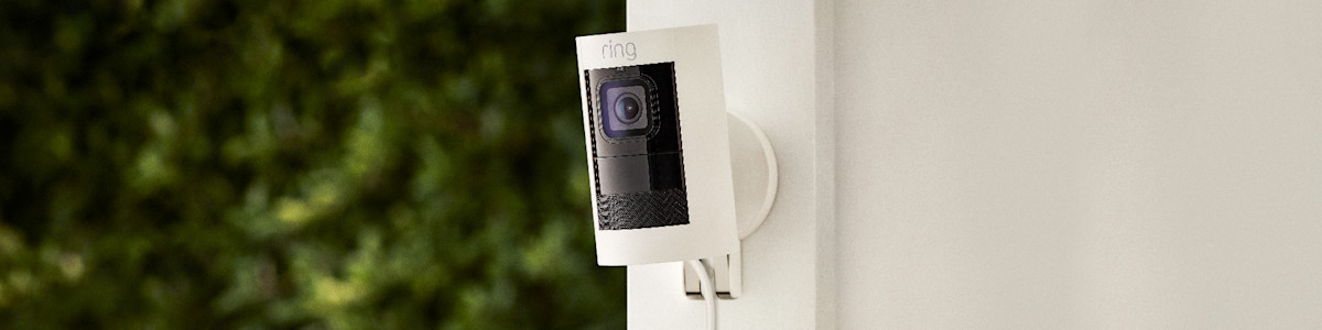 Ring security camera mounted on white exterior wall
