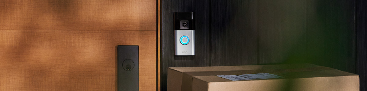 Ring Video Doorbell mounted on wooden door frame with parcels below
