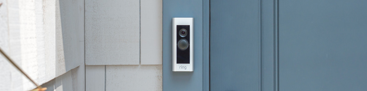 Ring Video Doorbell mounted on light blue door frame